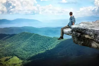 man sitting on mountain along appalachian trail